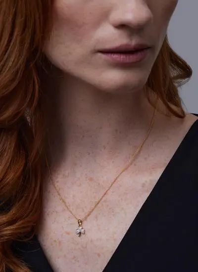 Close up image of red haired model wearing 14Ct Gold Vermeil Shamrock Pendant with Cubic Zirconia